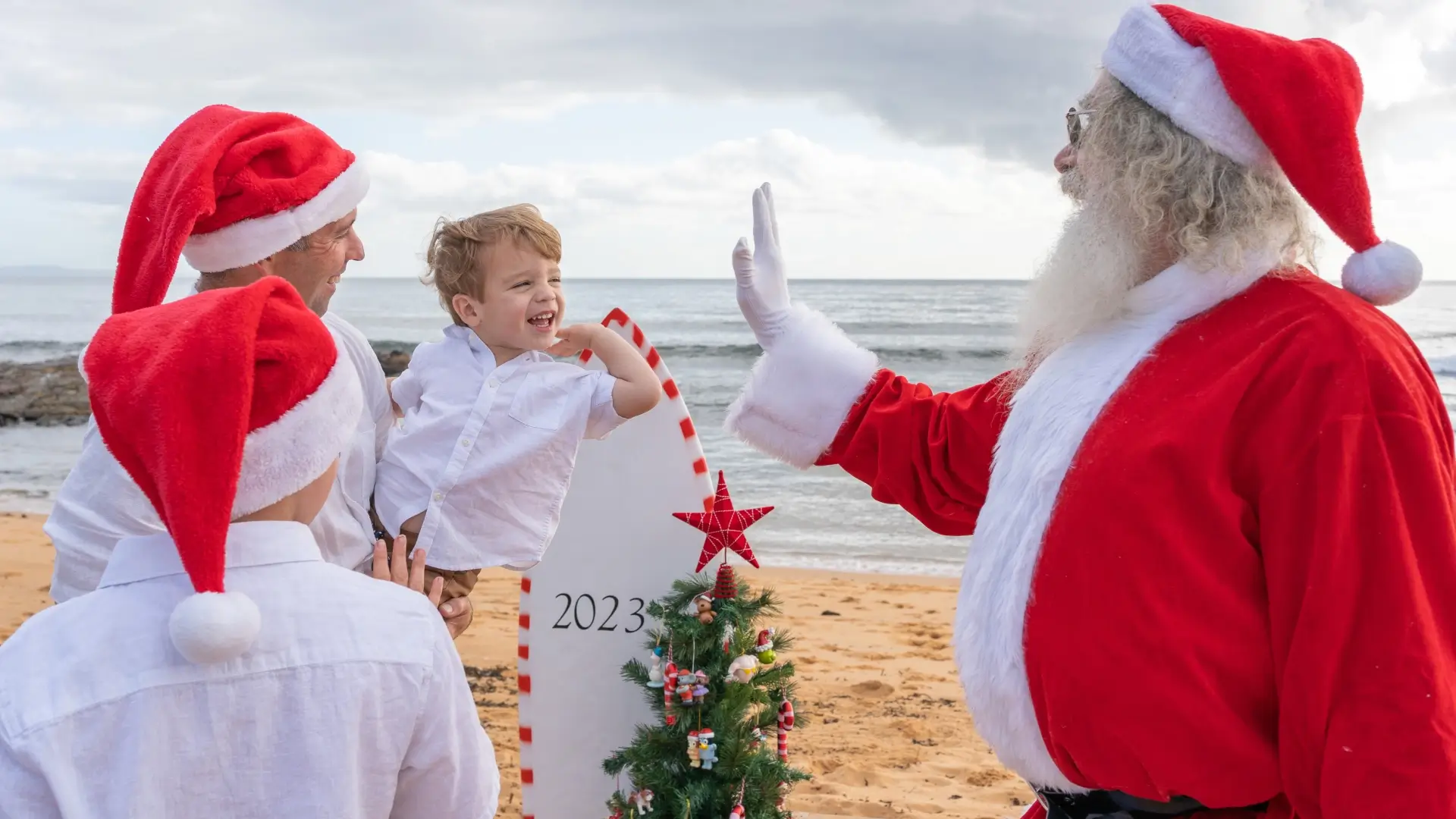 kid high five with santa on the beach photo booth